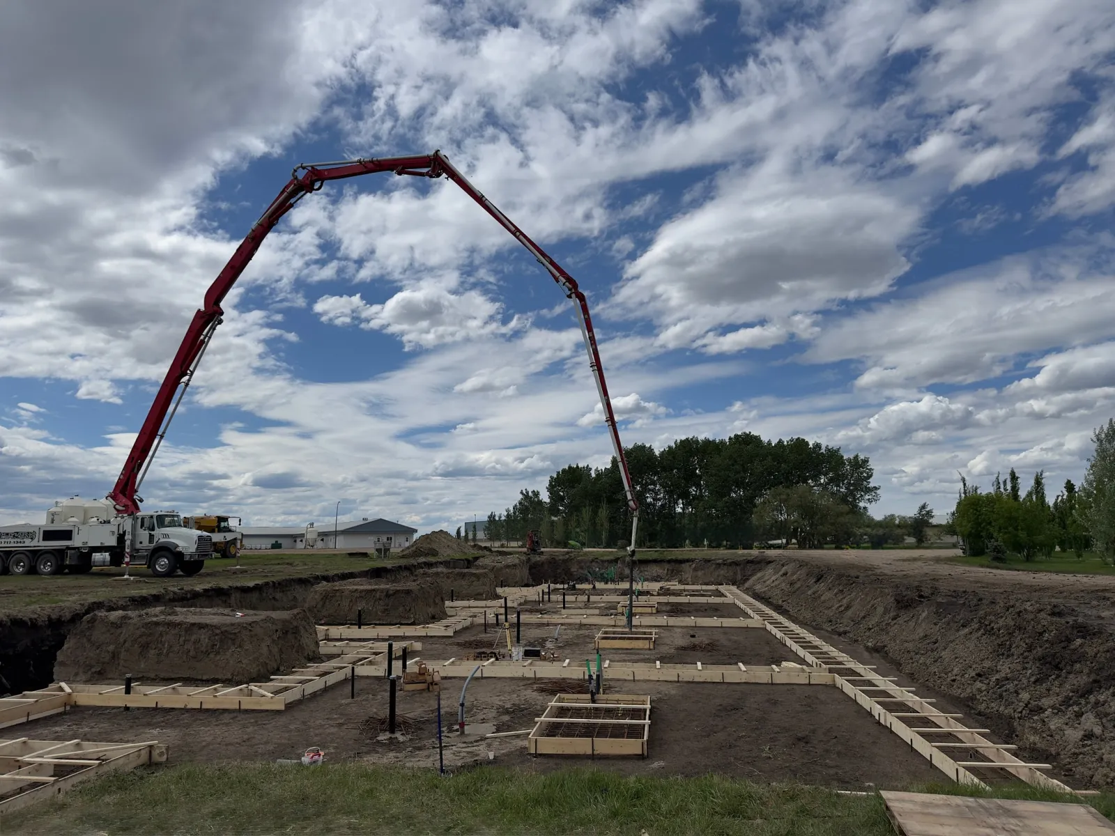 Concrete pump placing foundation footings