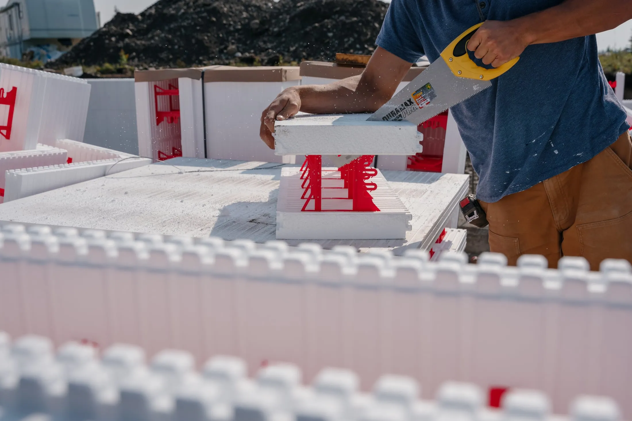 SuperForm ICF block being placed on a foundation wall