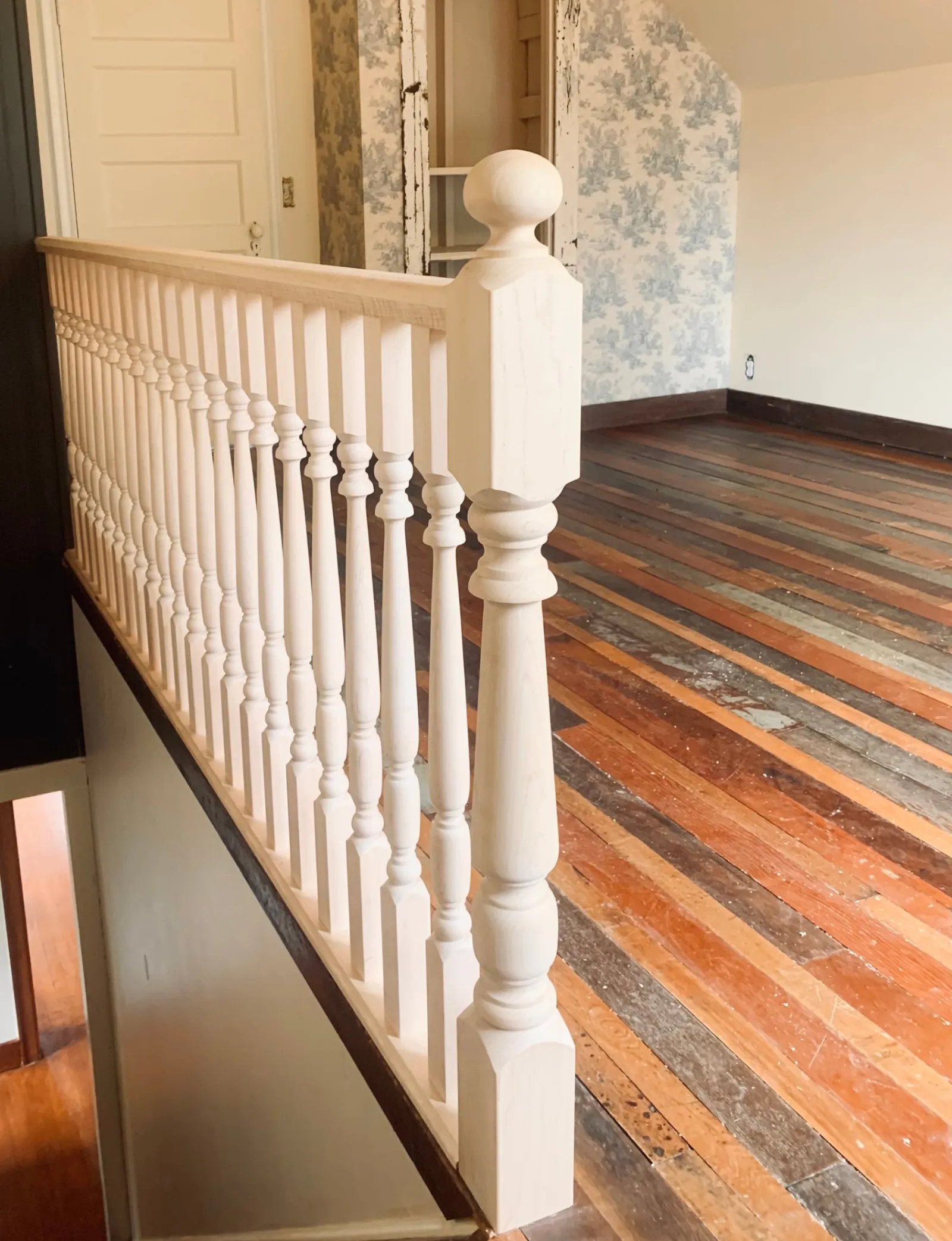 Detail of a turned newel post and spindles on a character home railing