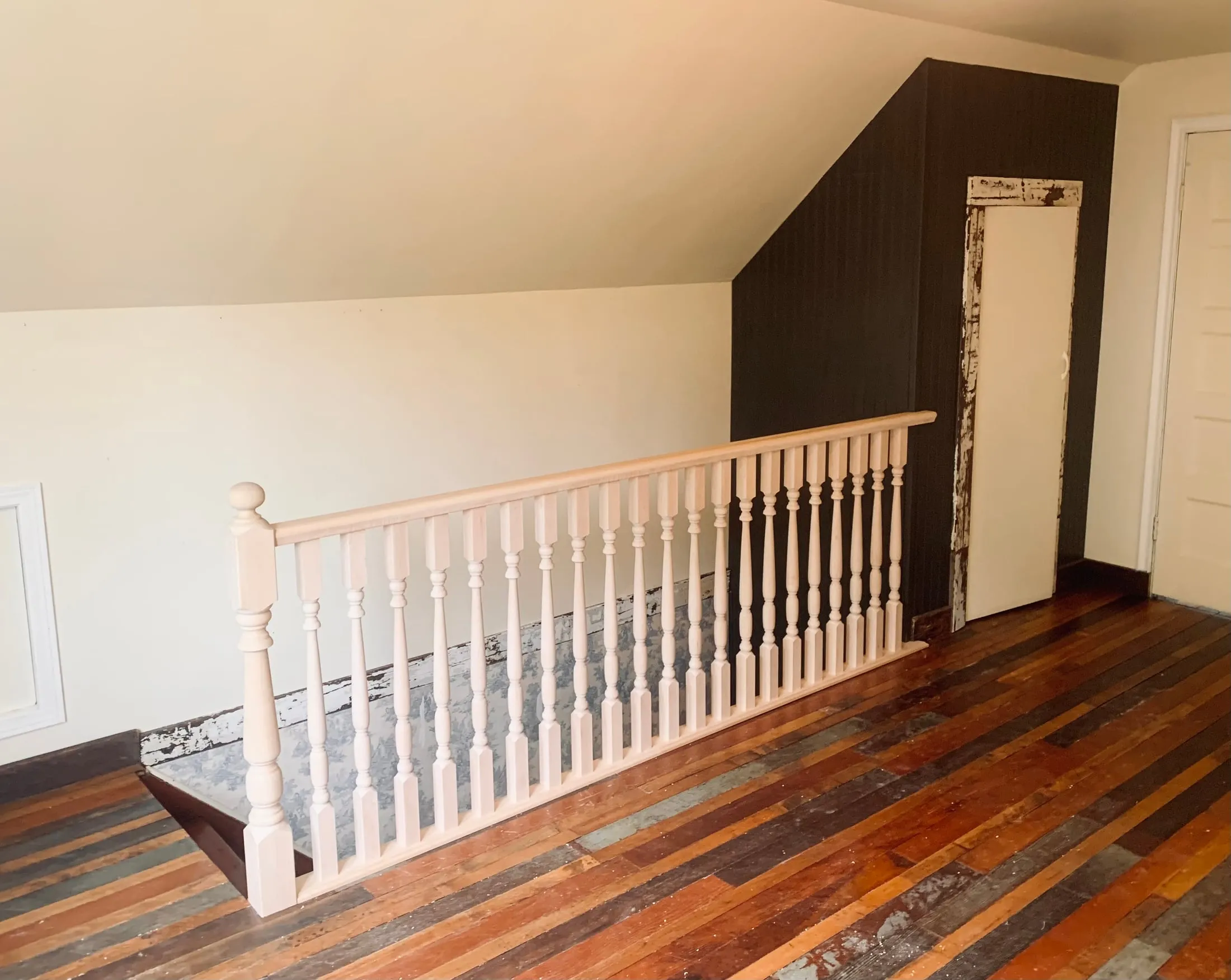 Solid wood railing built to match a character home, shown before finishing